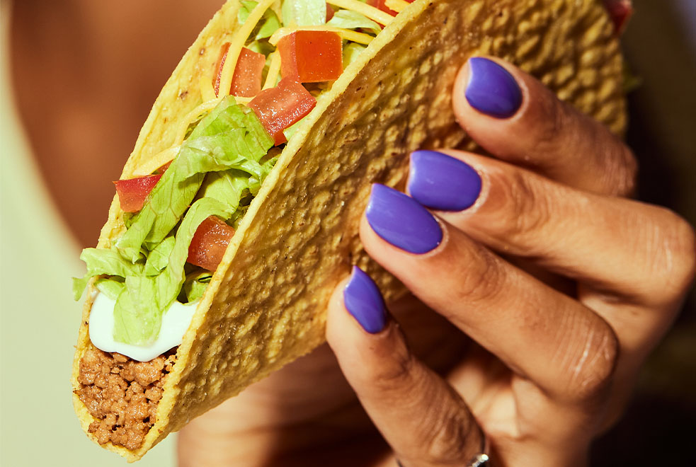 Hand holding a taco